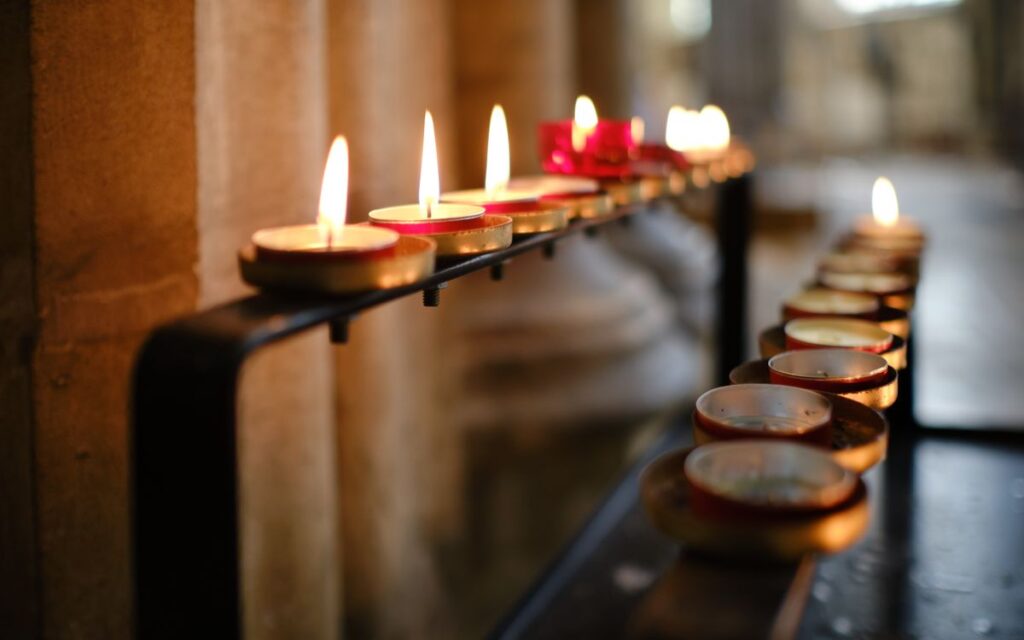 Warm candlelight reflects spirituality and tranquility in a church setting.