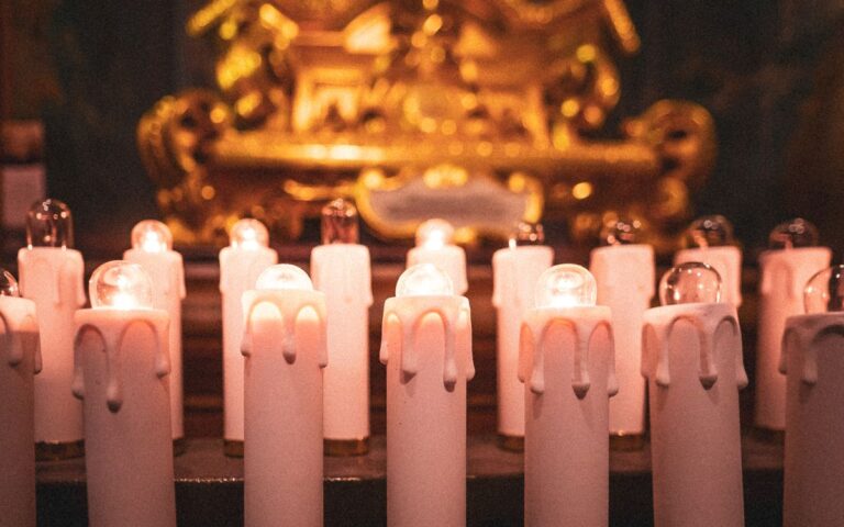 Candles glowing warmly on a church altar, creating a serene spiritual ambiance.