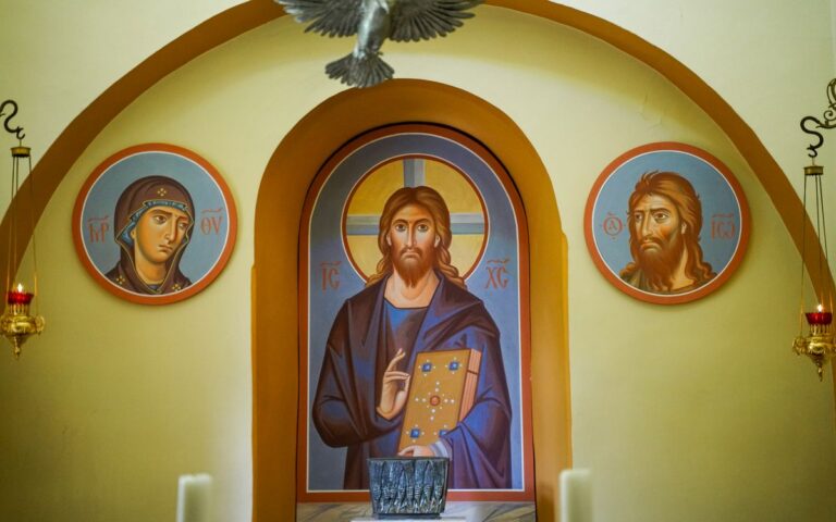 Beautiful Orthodox iconography inside a church with depictions of Jesus and saints.