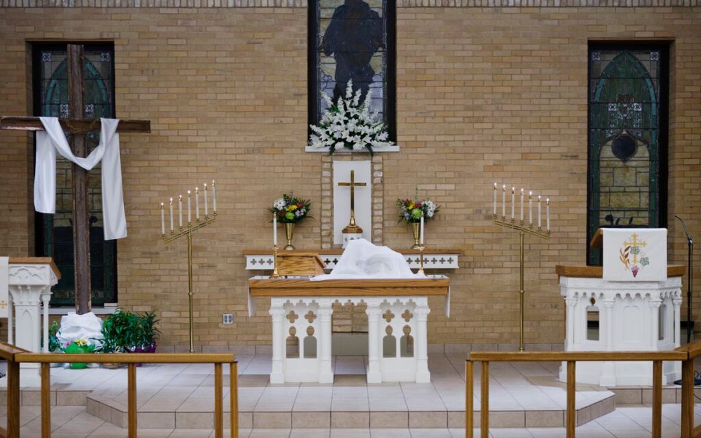 Beautifully adorned church altar in Berlin, Wisconsin, reflecting Easter spirit with crosses and candles.