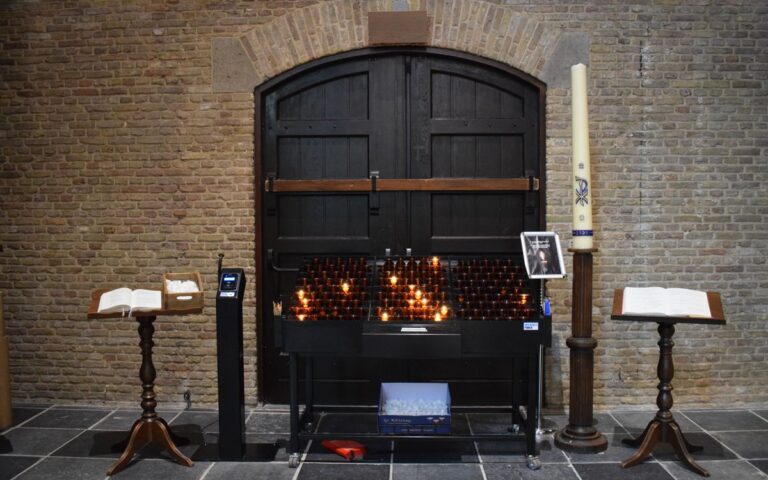 A serene church setting with lit candles, open prayer books, and traditional wooden furniture.