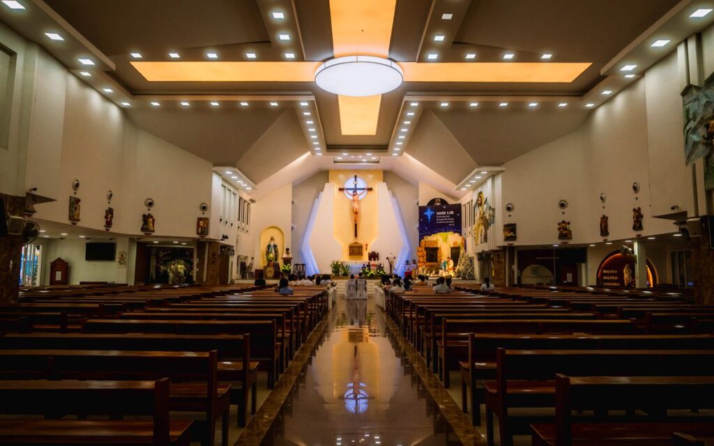 Elegant church interior in Ho Chi Minh City with ornate altar and seating.