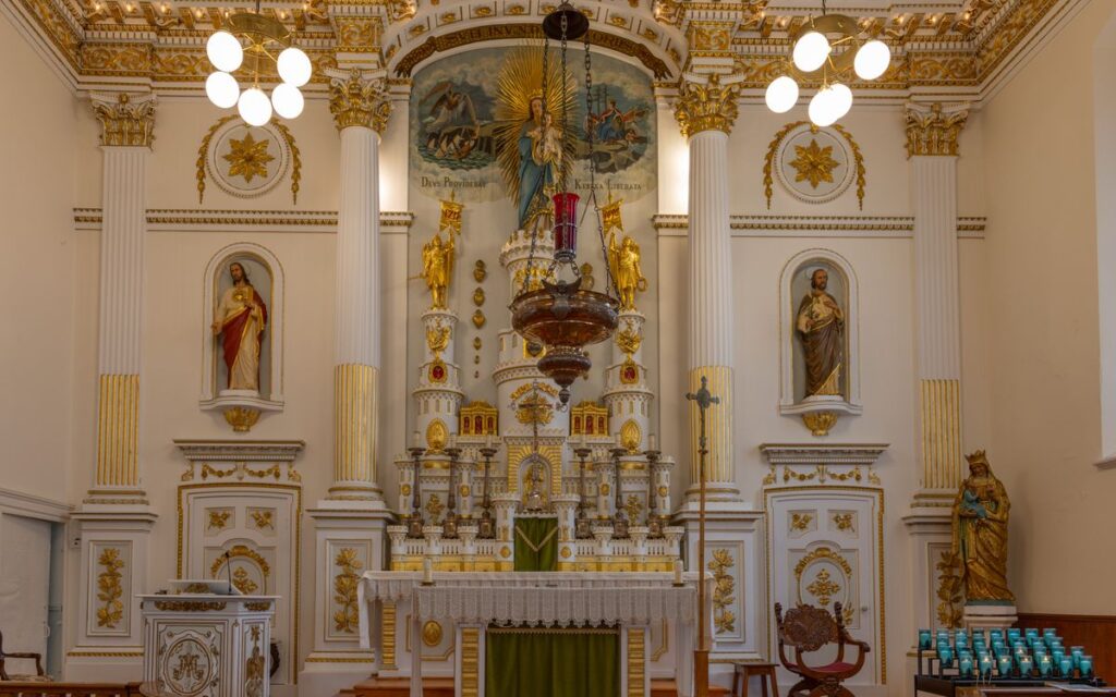 Intricate church altar with religious statues and artistic decor.