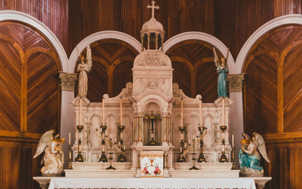 Exquisite church altar featuring detailed angelic sculptures and ornate architecture.